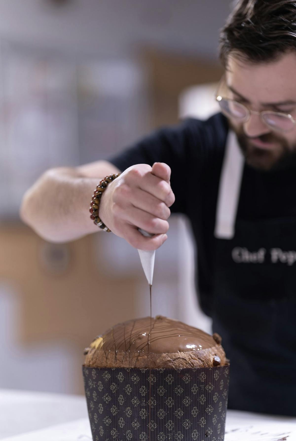 a person holding a piece of cake on a table