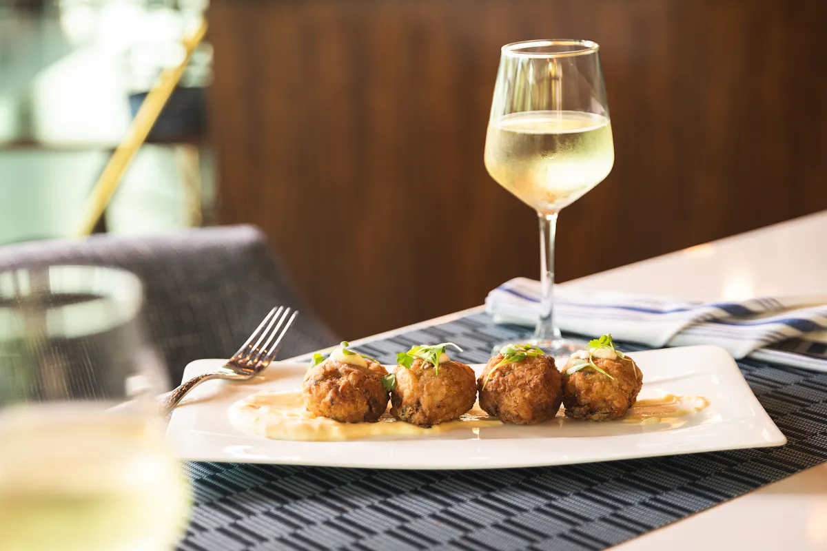 a plate of food and a glass of wine