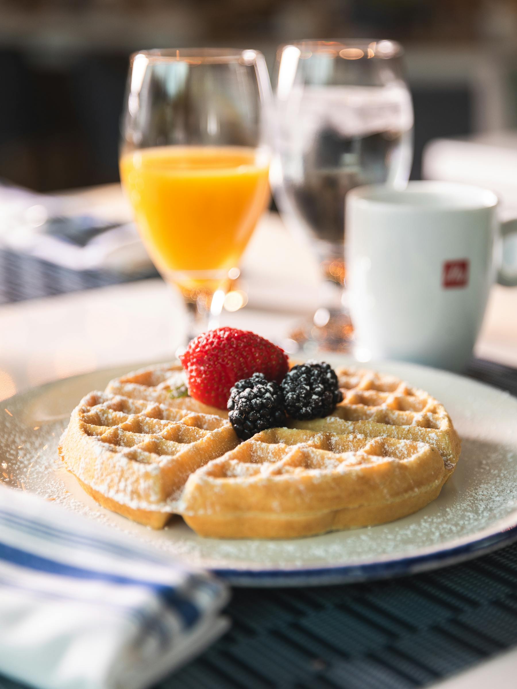 a close up of a plate of food and a glass of orange juice