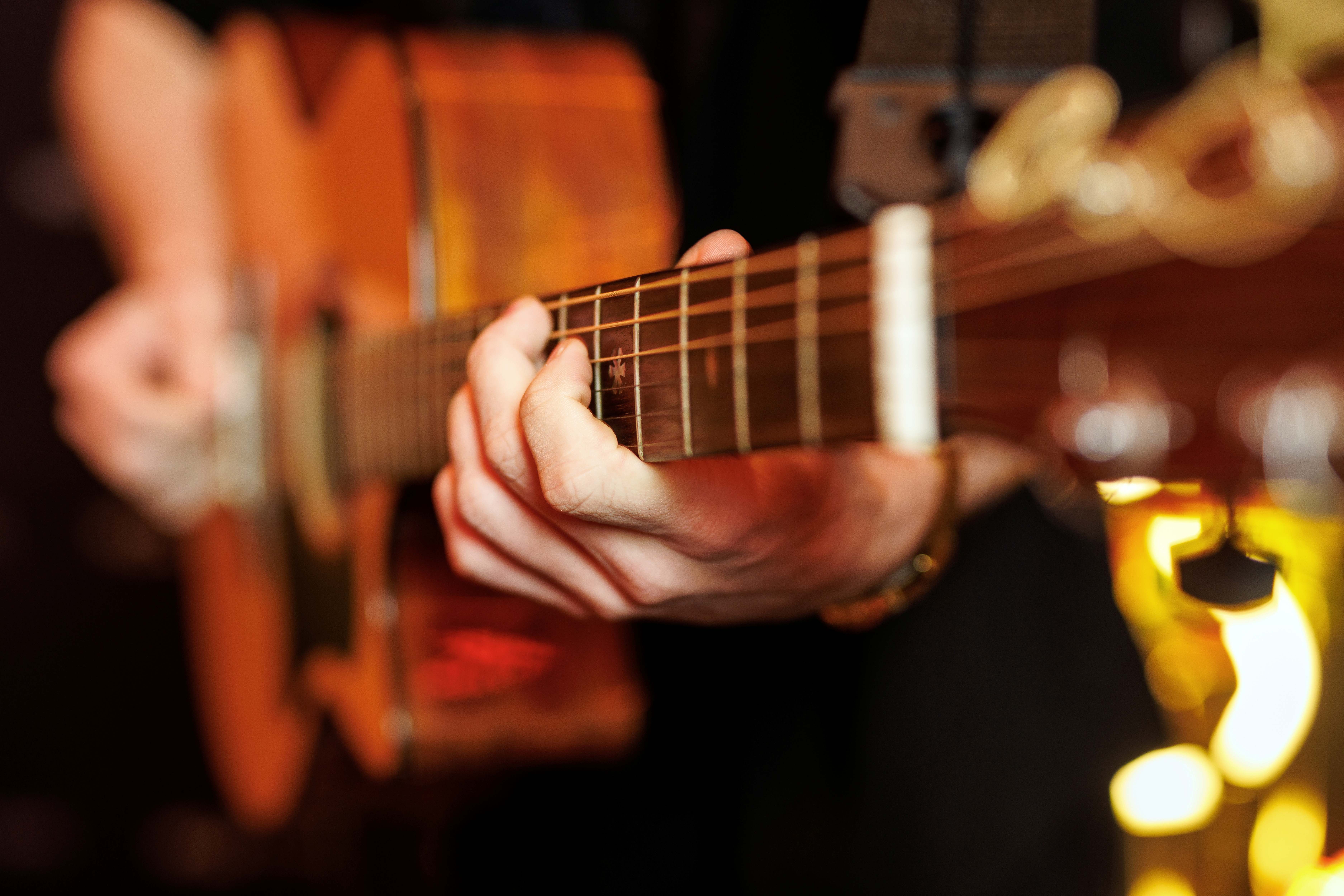 Close up of someone playing an acoustic guitar
