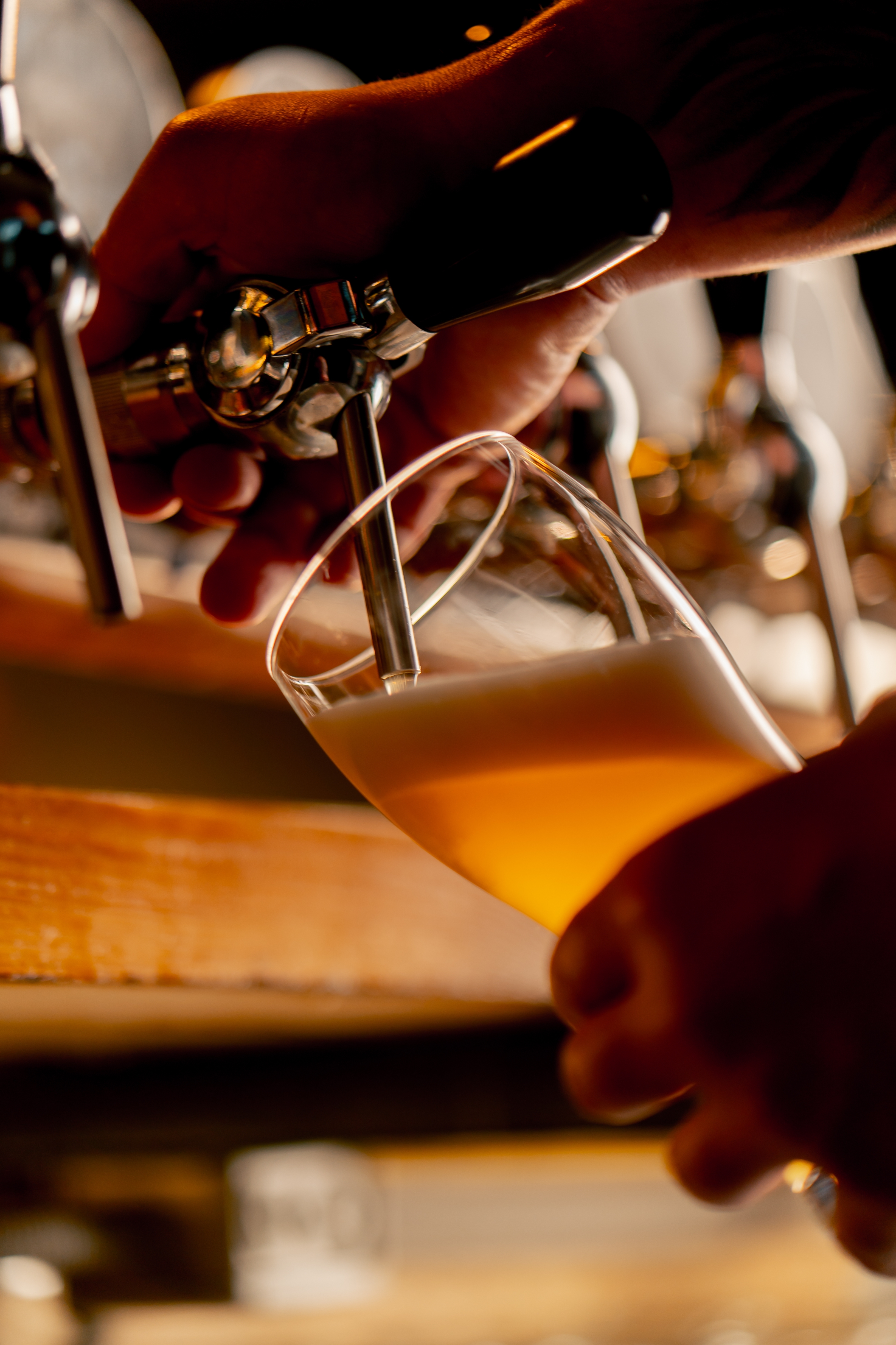 Close-up of bartender pouring draft beer