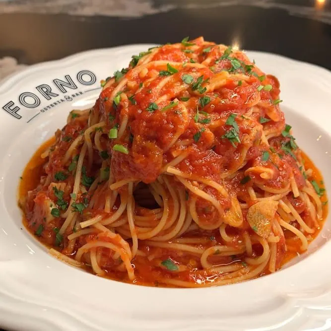 Spaghettini topped with tomato sauce and fresh herbs at Forno Osteria & Bar.