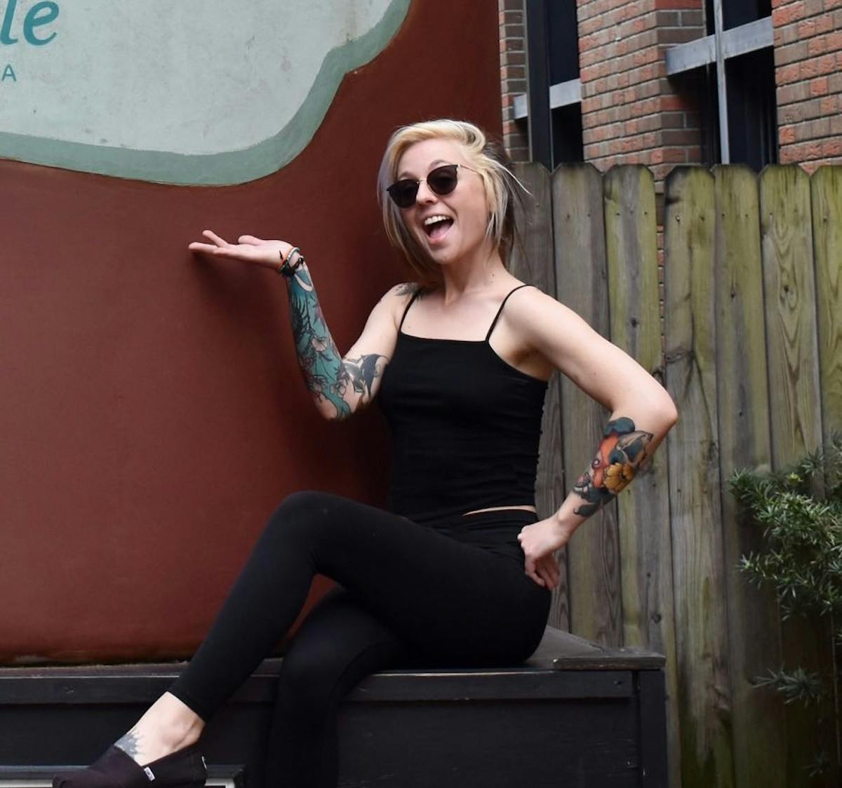 a woman sitting on a bench talking on a cell phone