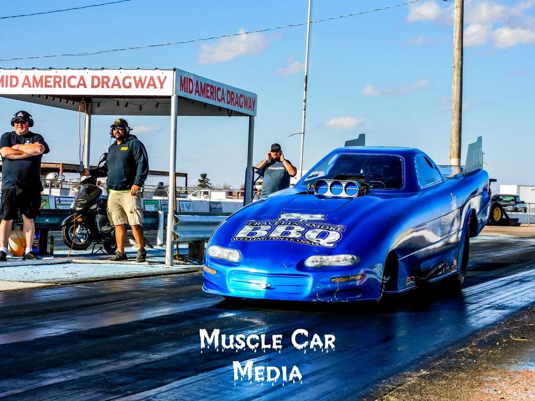 a person in a blue car on a road