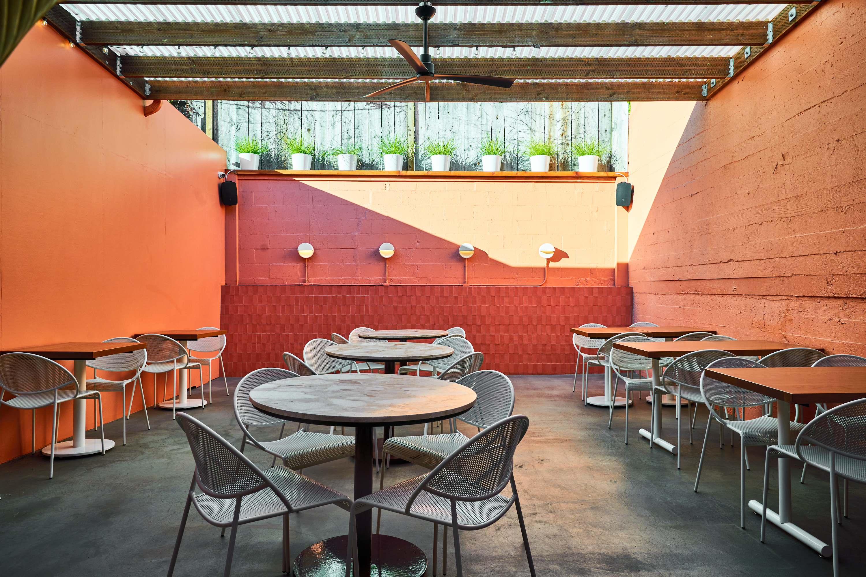 a patio with tables and chairs
