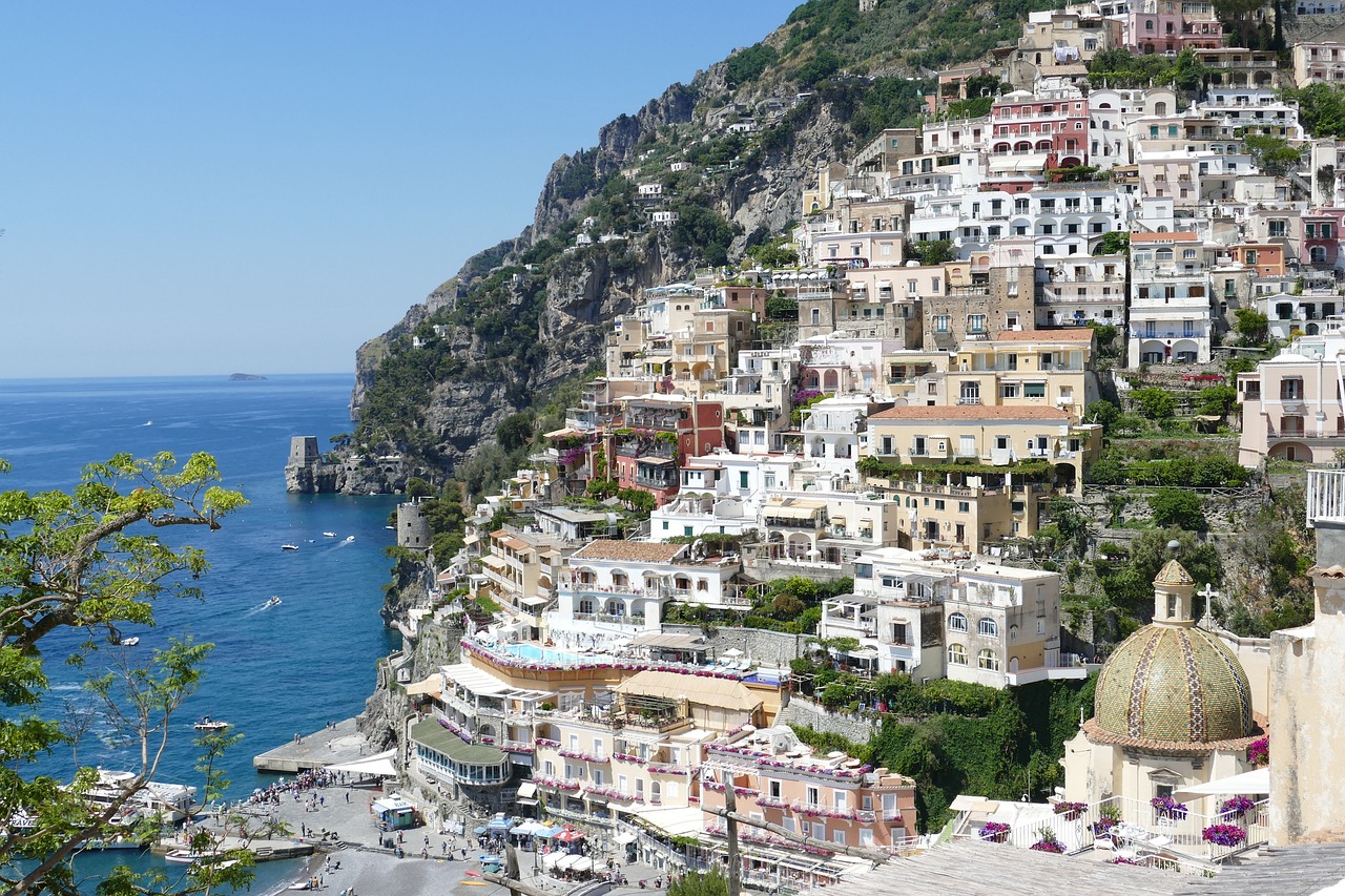 a large building with Amalfi Coast in the background