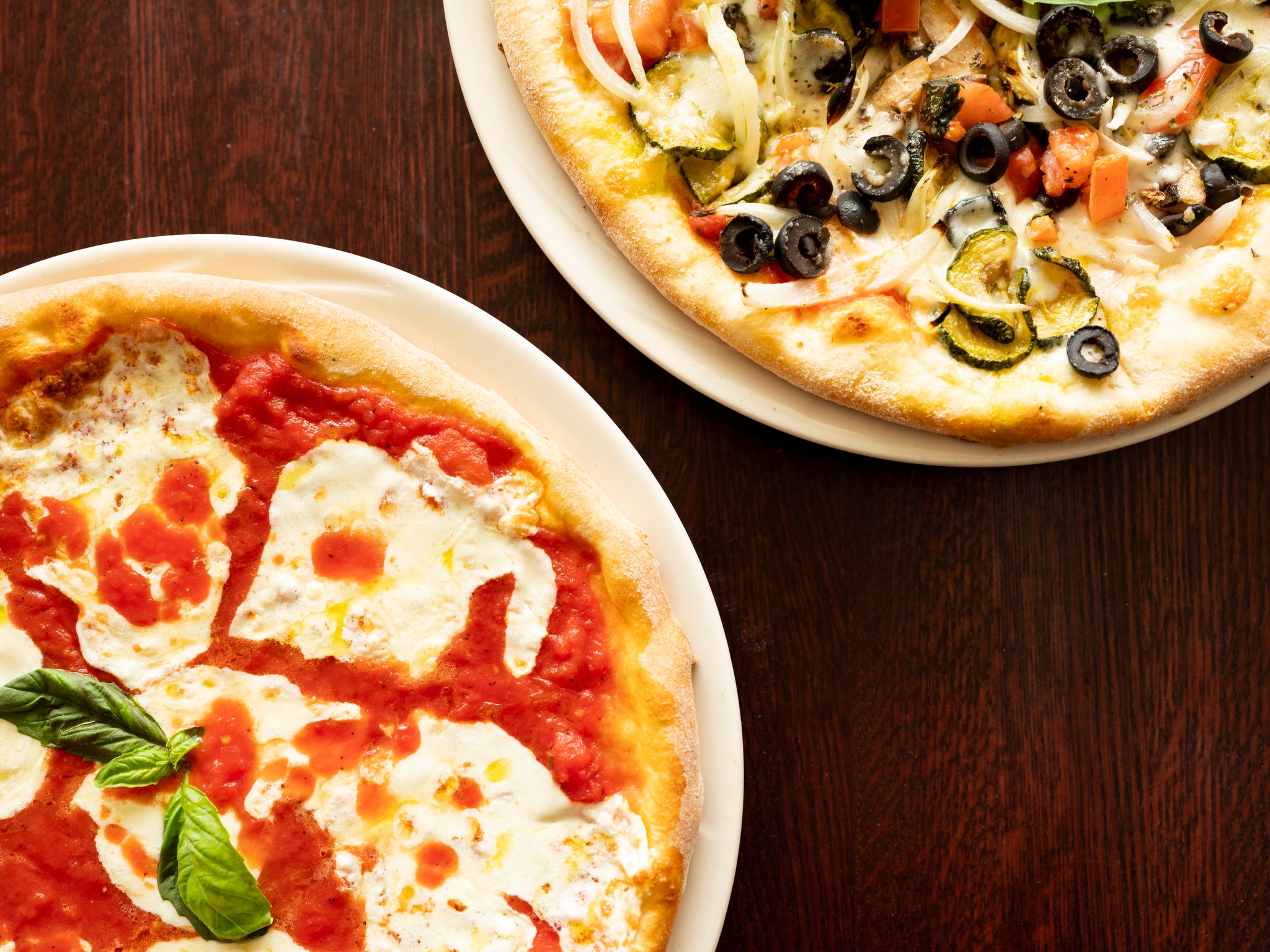 a pizza sitting on top of a wooden table