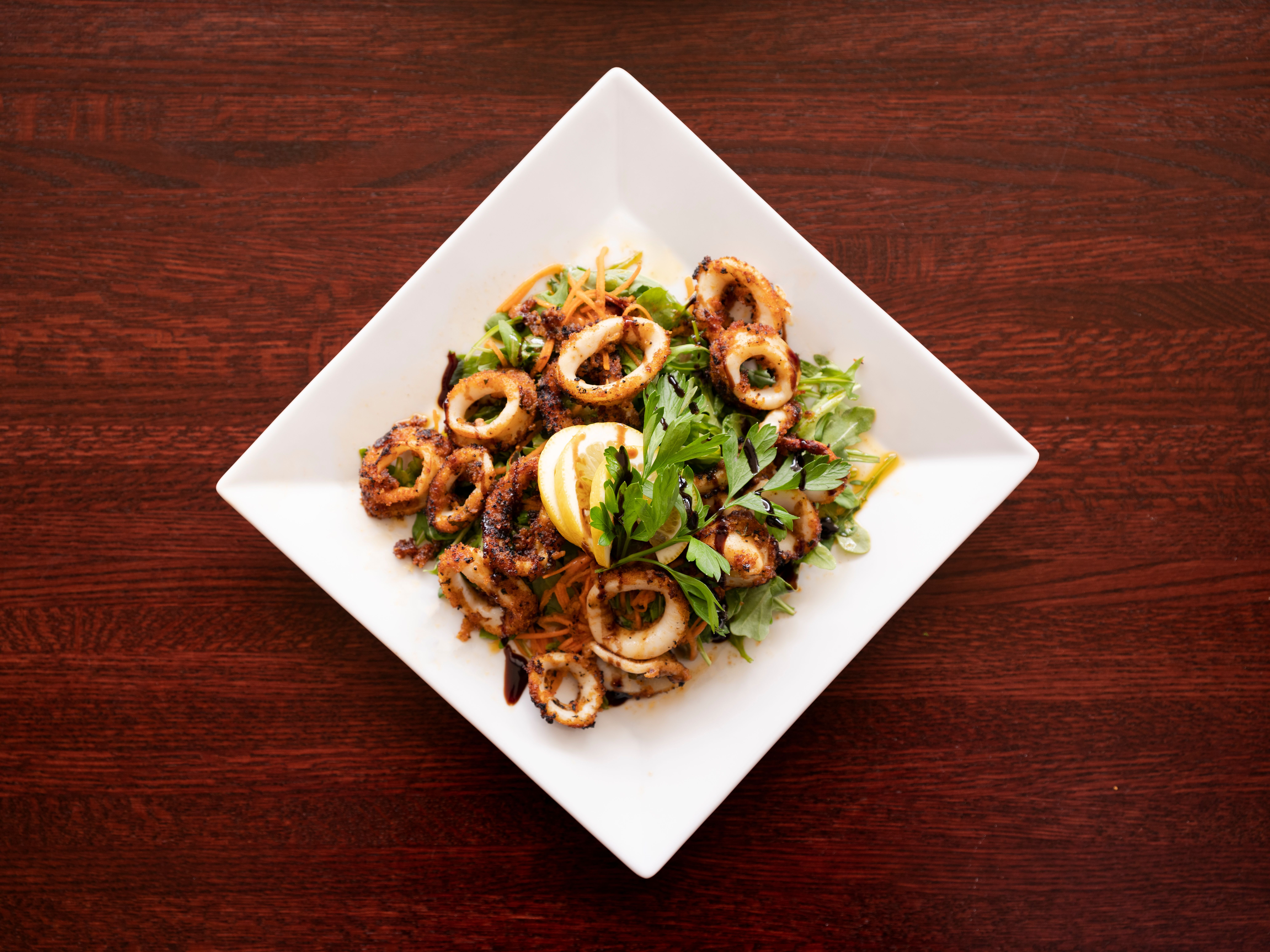 a plate of food sitting on top of a wooden table