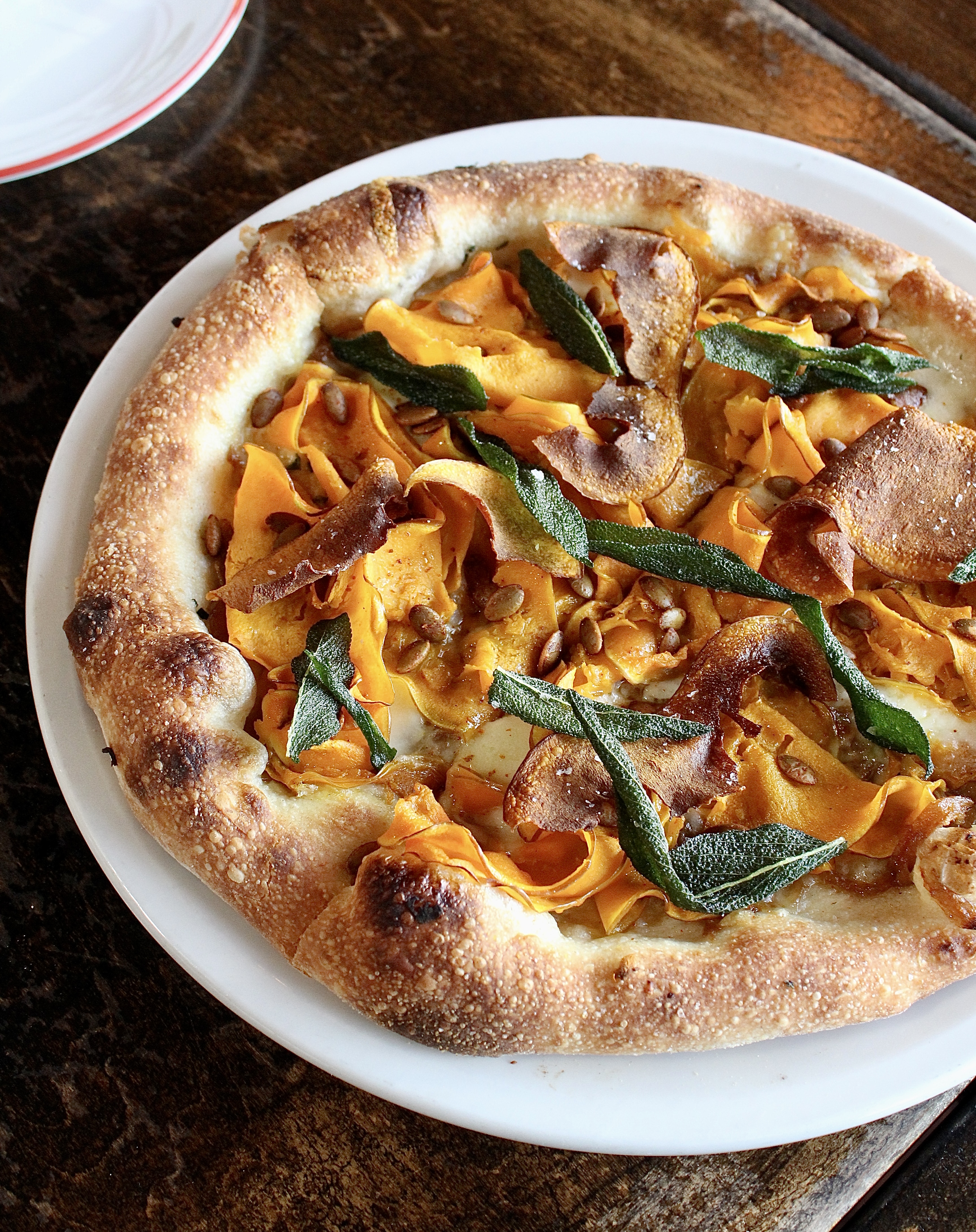 a close up of a plate of food with a slice of pizza