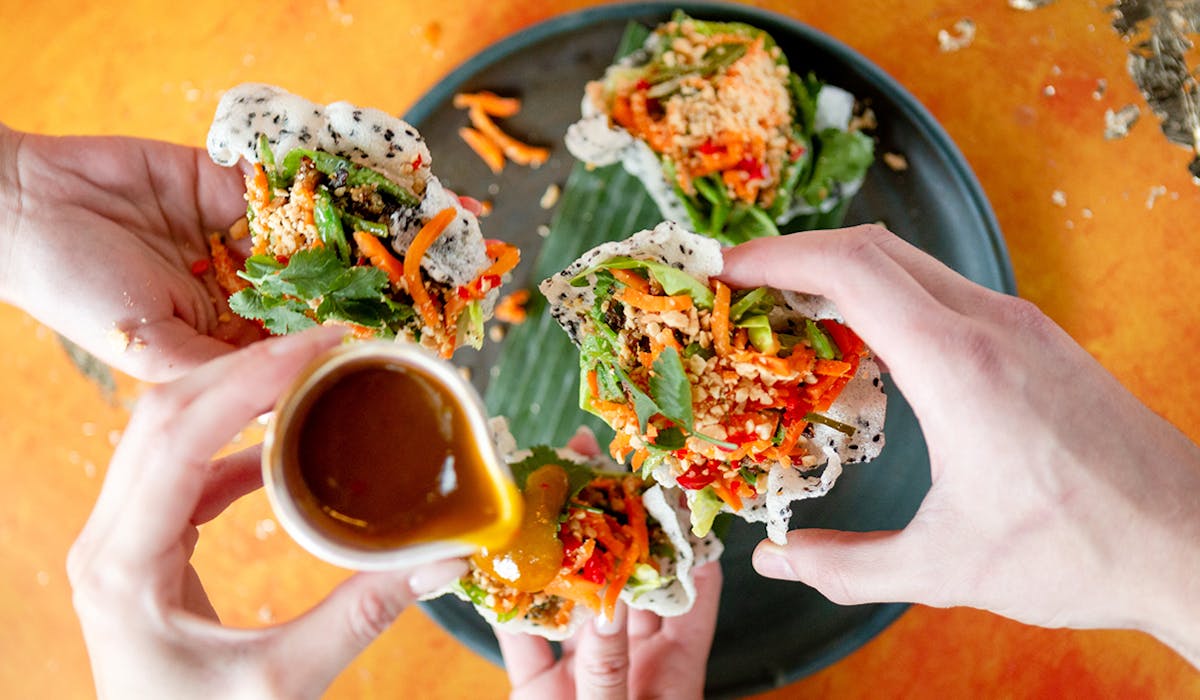 a hand holding a bowl of food