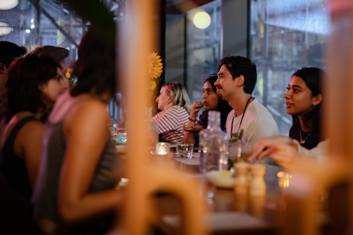 a group of people sitting at a table with wine glasses