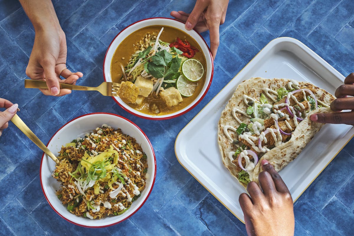 a person holding a bunch of food on a plate
