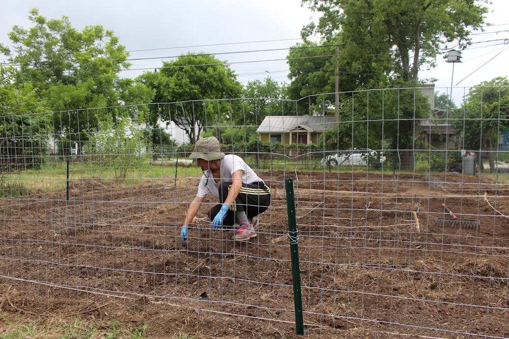 a horse is eating hay in a fenced in area