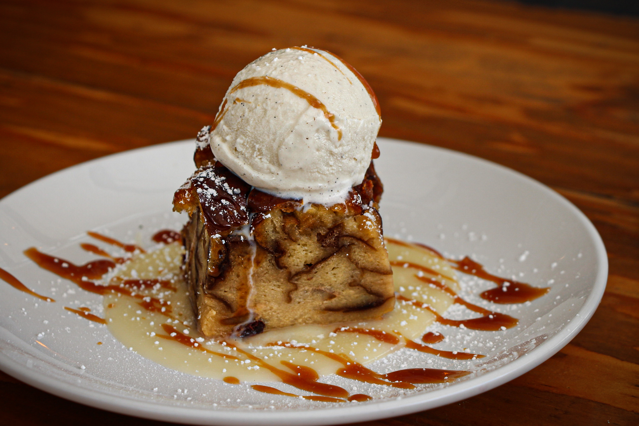 a close-up of bread pudding with a scoop of ice cream