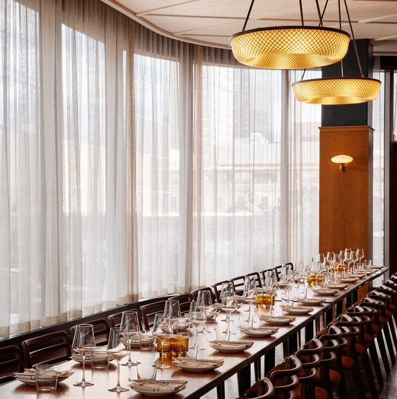 a group of men standing next to a window