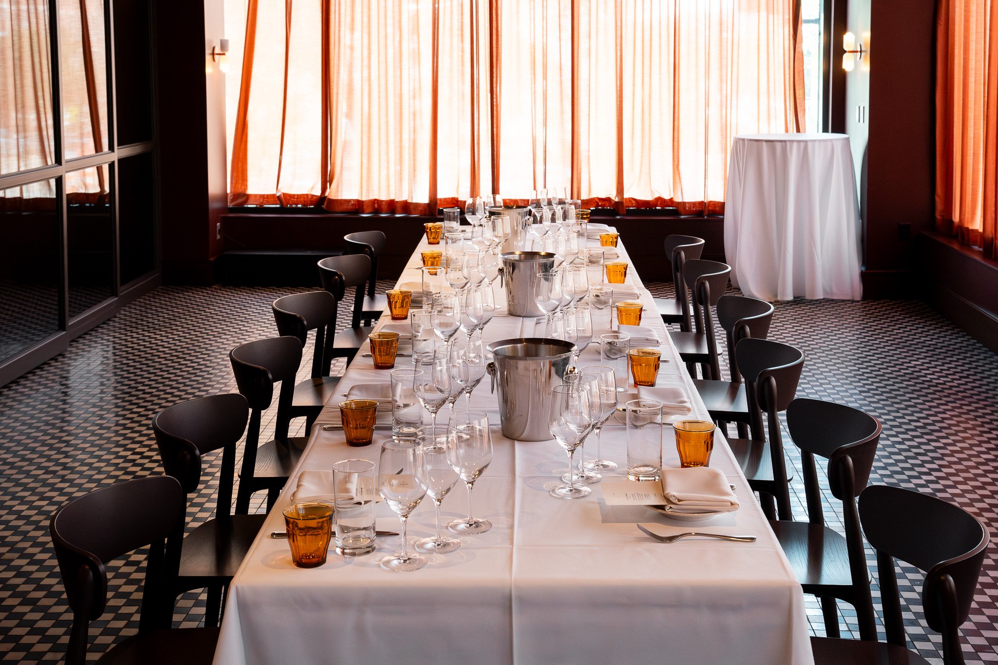 a long table with glasses and utensils