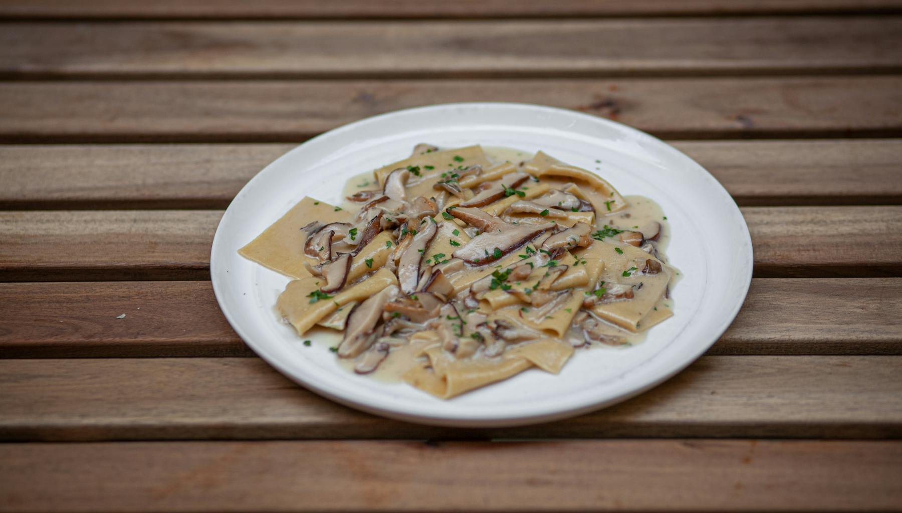 a plate of food sitting on top of a wooden table