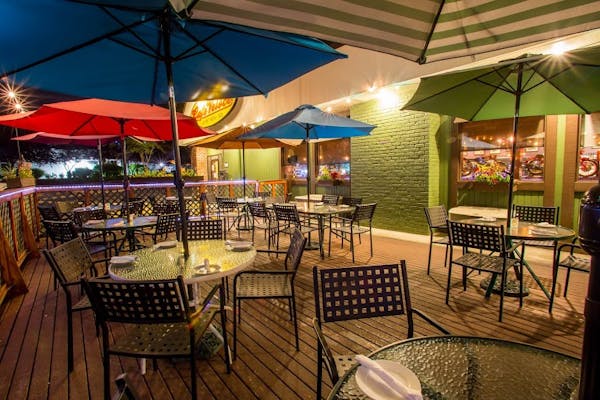 a dining room table with a green umbrella