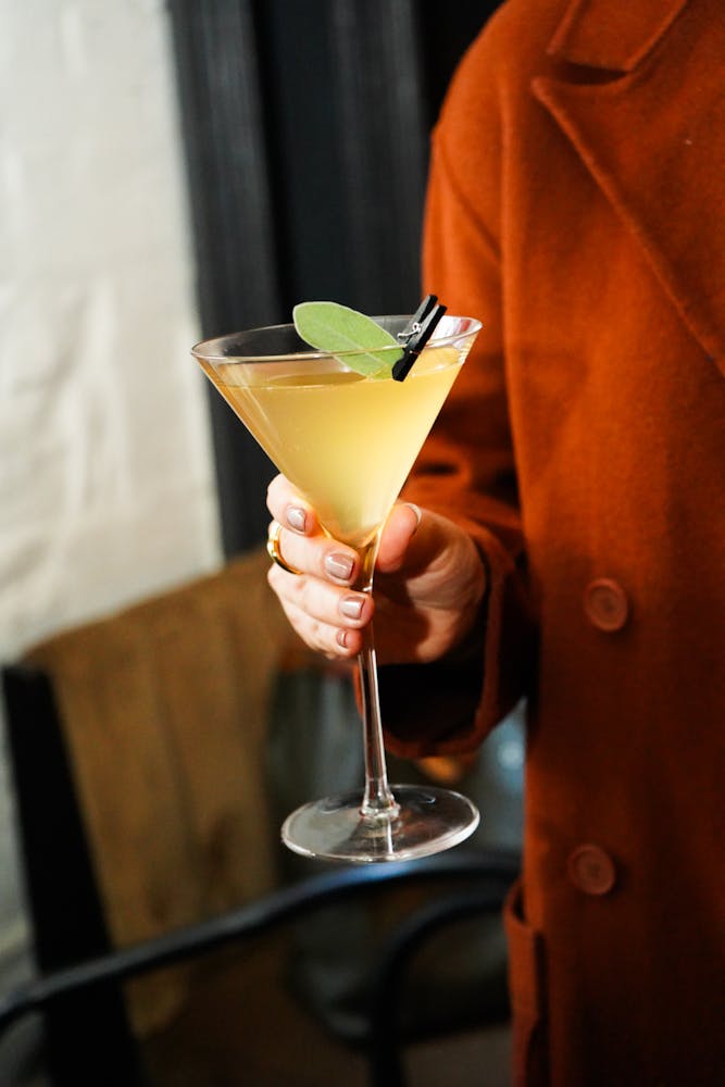 a person sitting at a table with a glass of wine