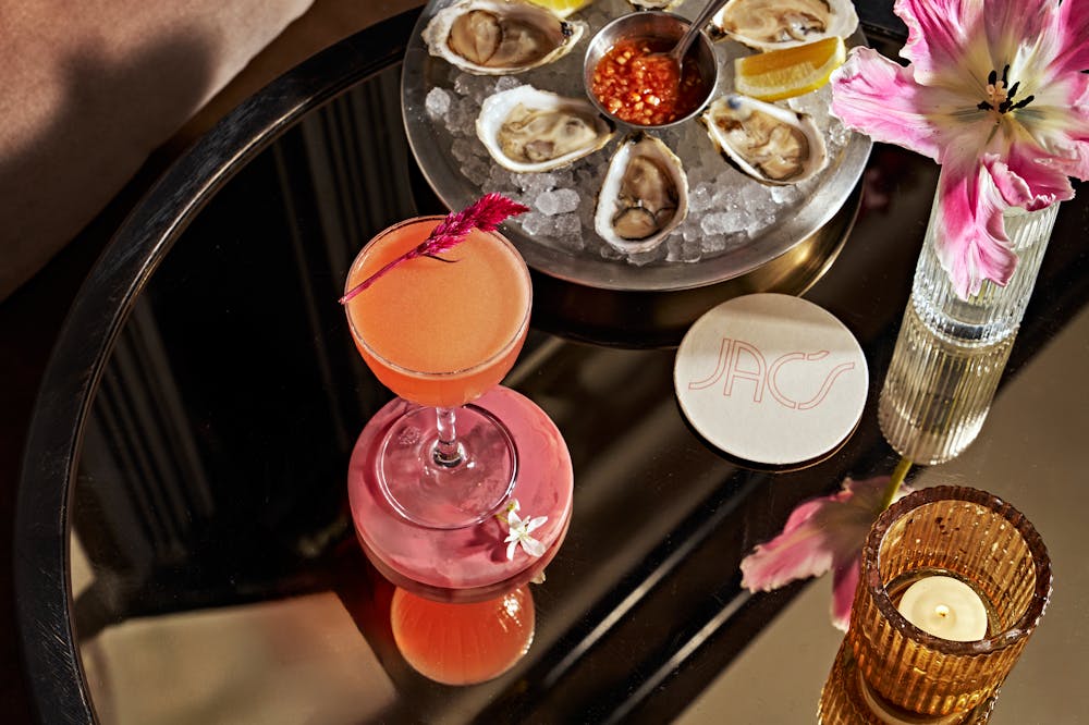 A photo of the Lipstick on the Rim cocktail with oysters