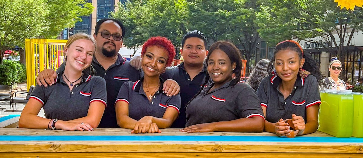 A diverse group of individuals smiling and posing