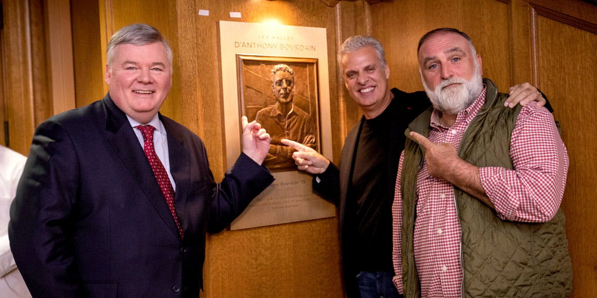 three men pointing a painting