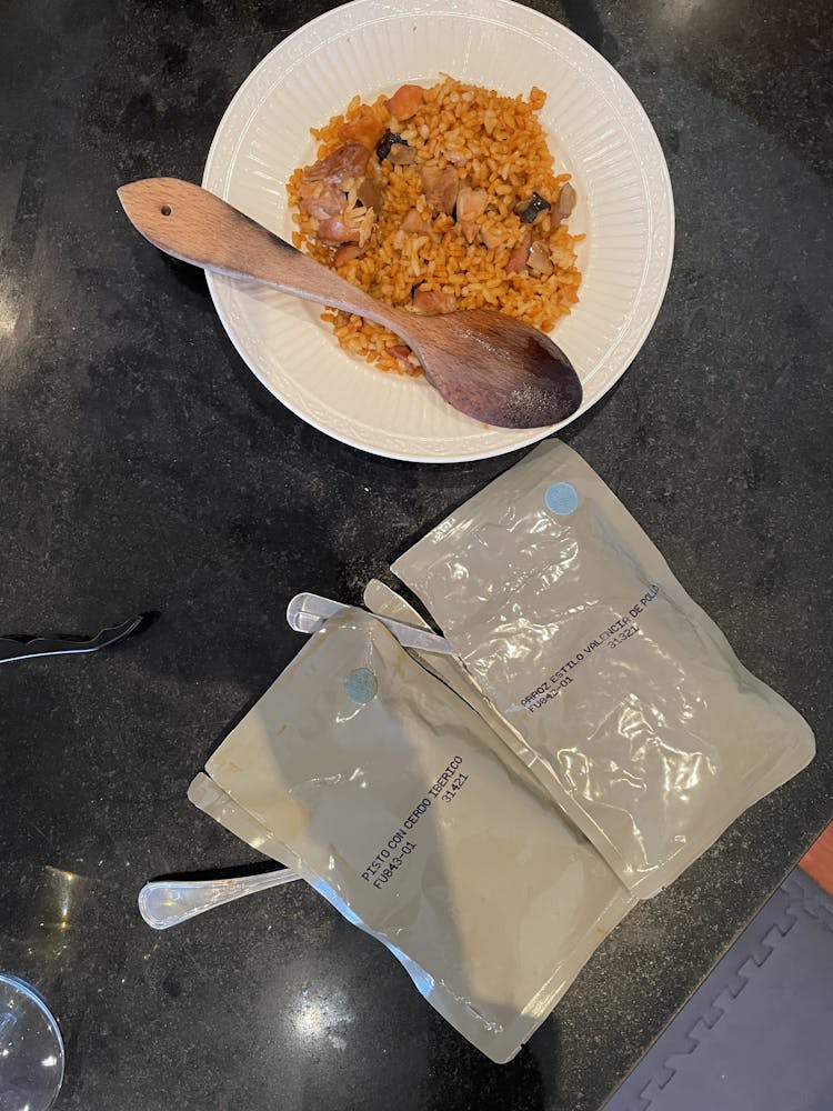 a plate with paella and two spoons