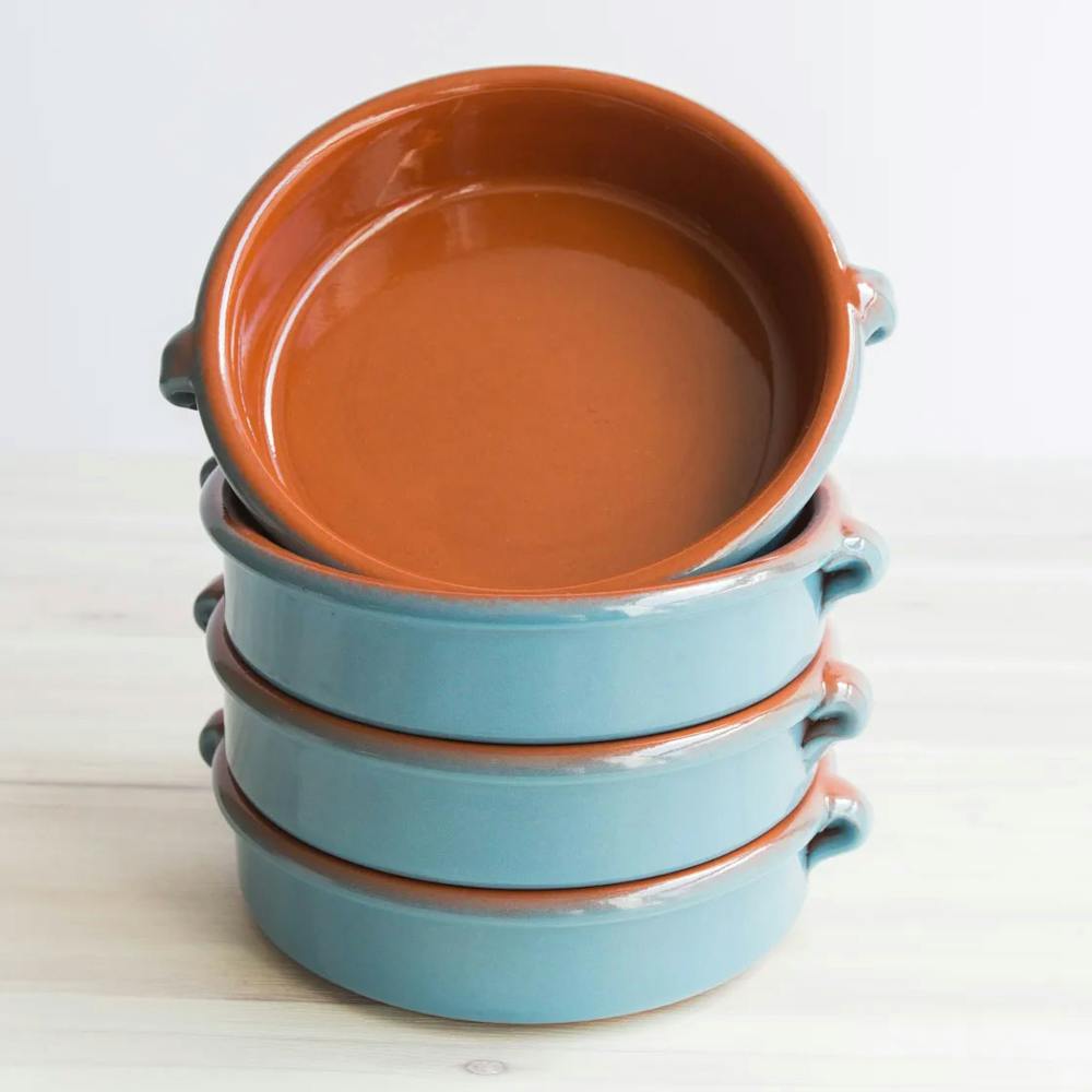 A stack of four bowls in blue and orange