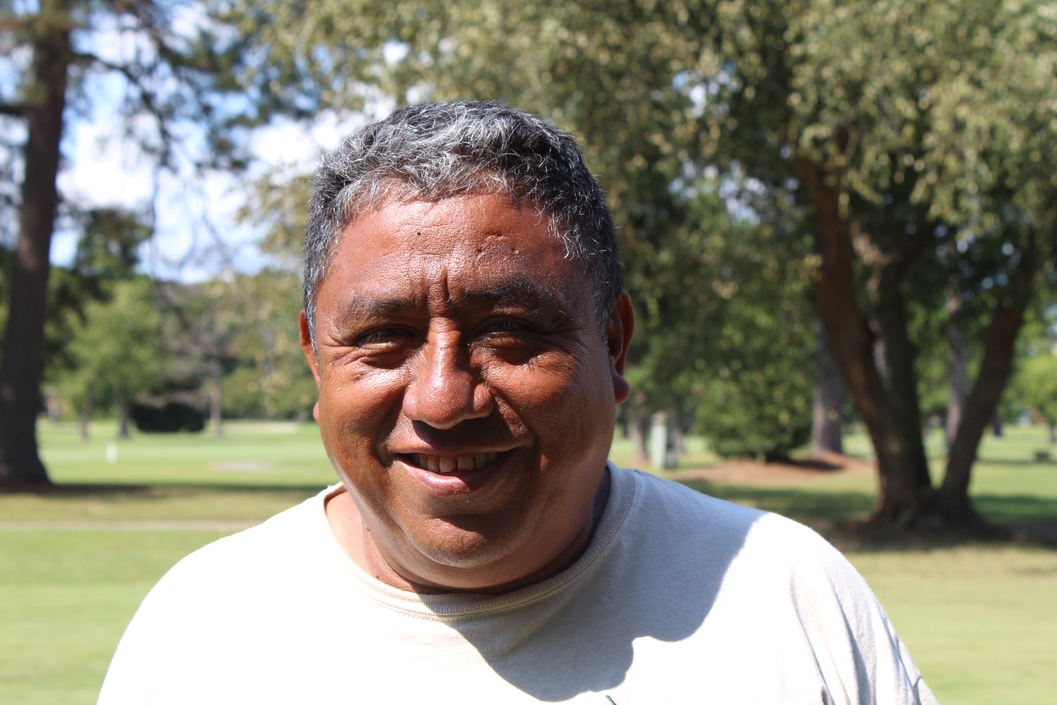 Gerardo Ortiz smiling in a park