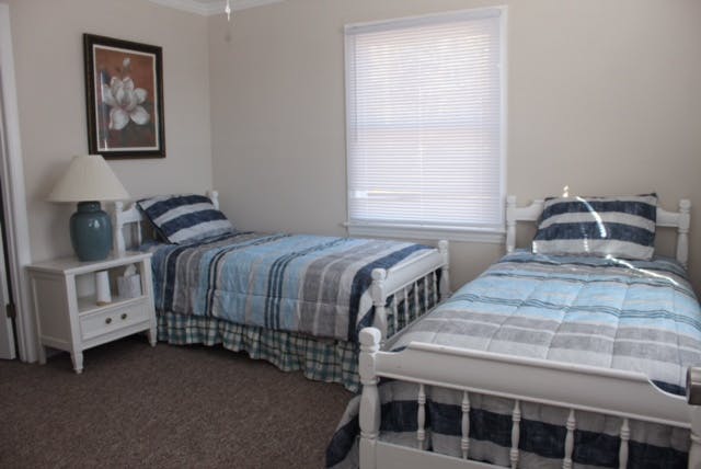 a bedroom with a bed and desk in a room