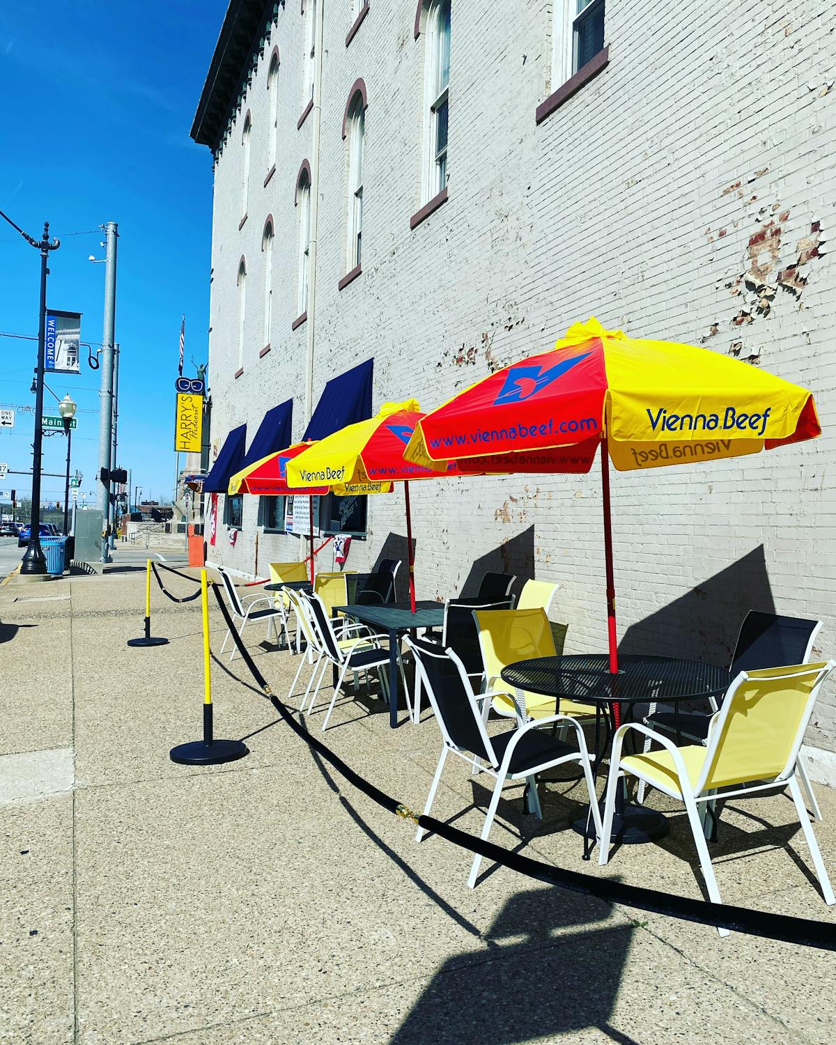 a group of people sitting in a chair with a colorful umbrella