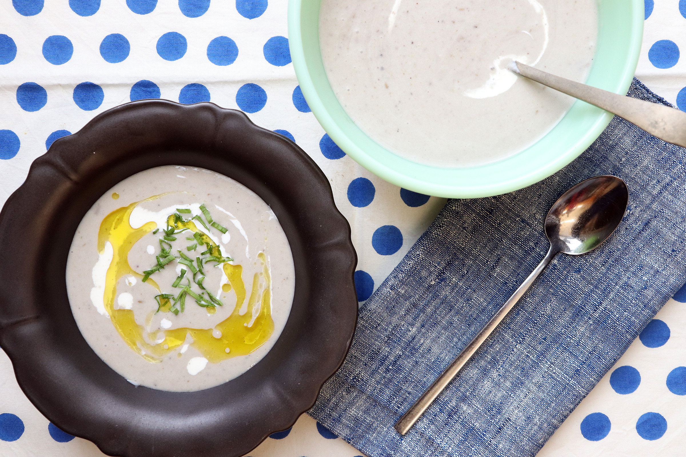 a bowl of soup next to a spoon