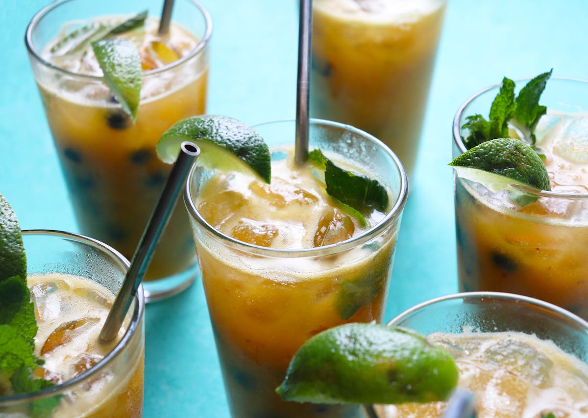 a glass of orange juice next to a cup of coffee