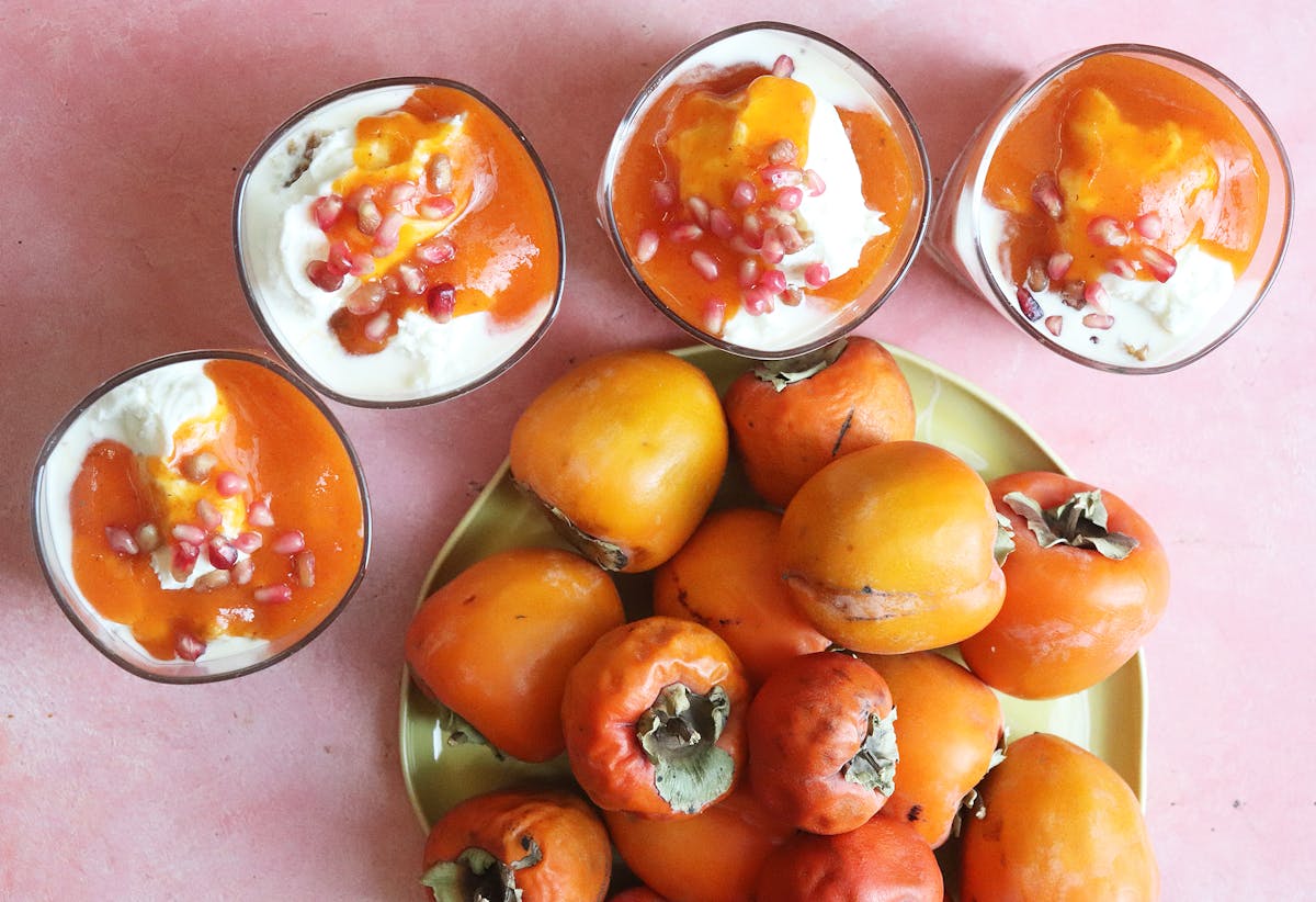 a bowl of oranges on a table