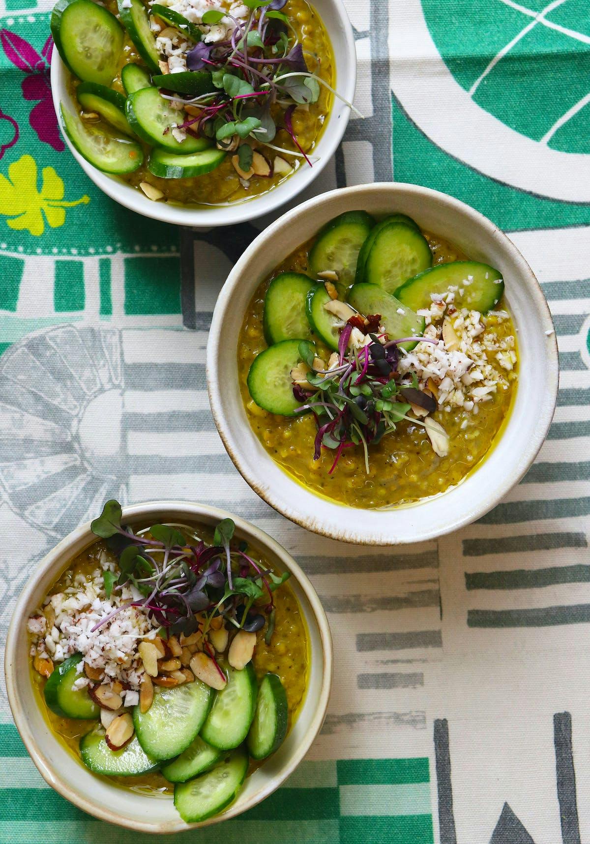 a plate of food with a green bowl on a table