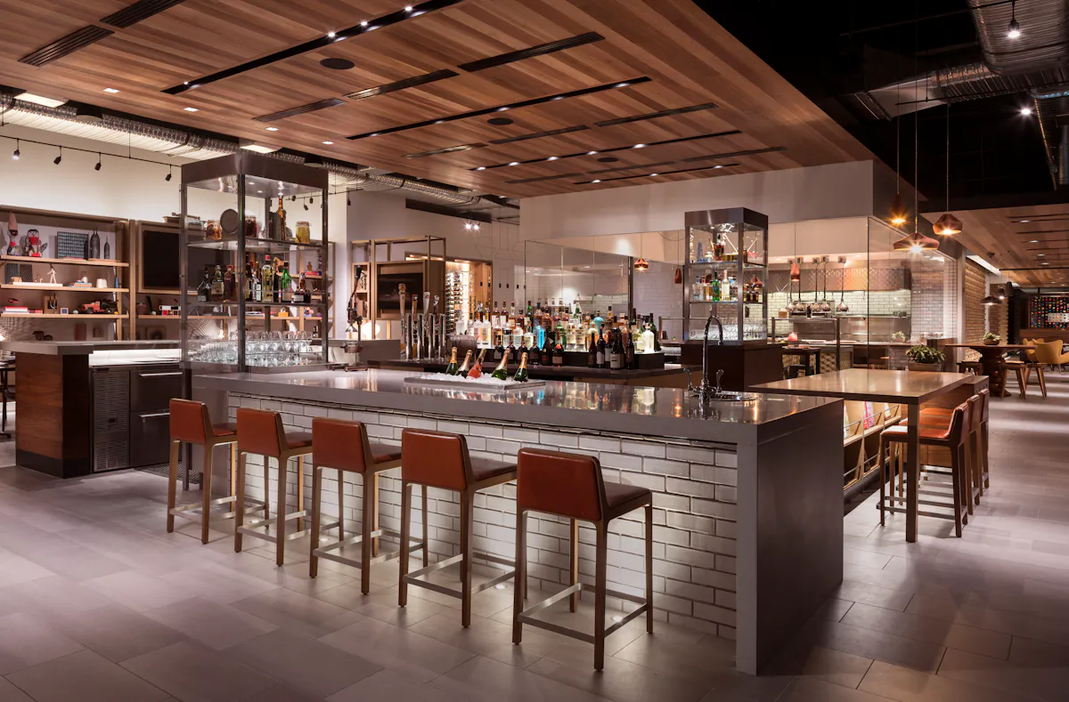 a bar with chairs and a counter