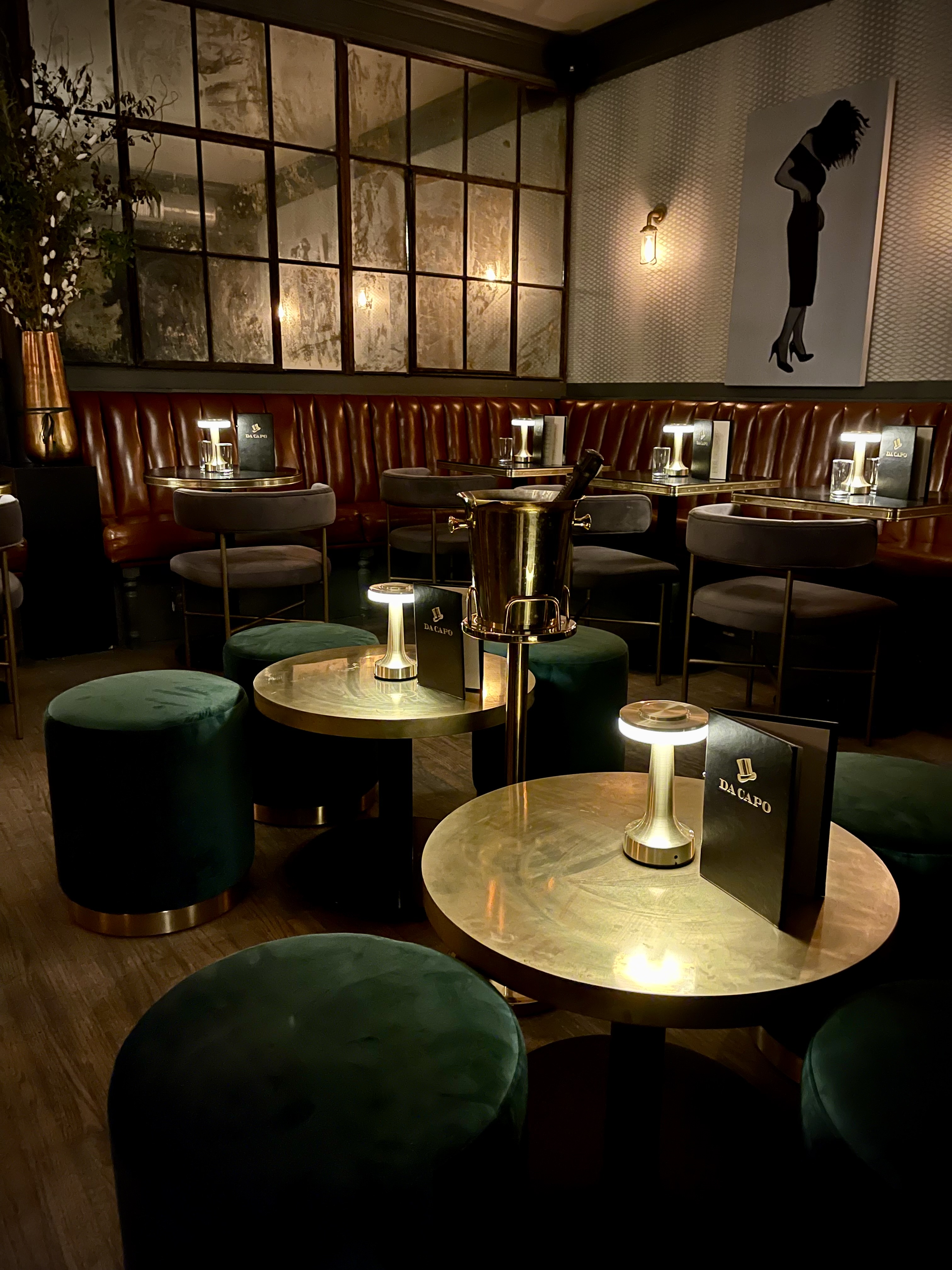 a moody dark, upscale elegant room filled with furniture and vase on a table