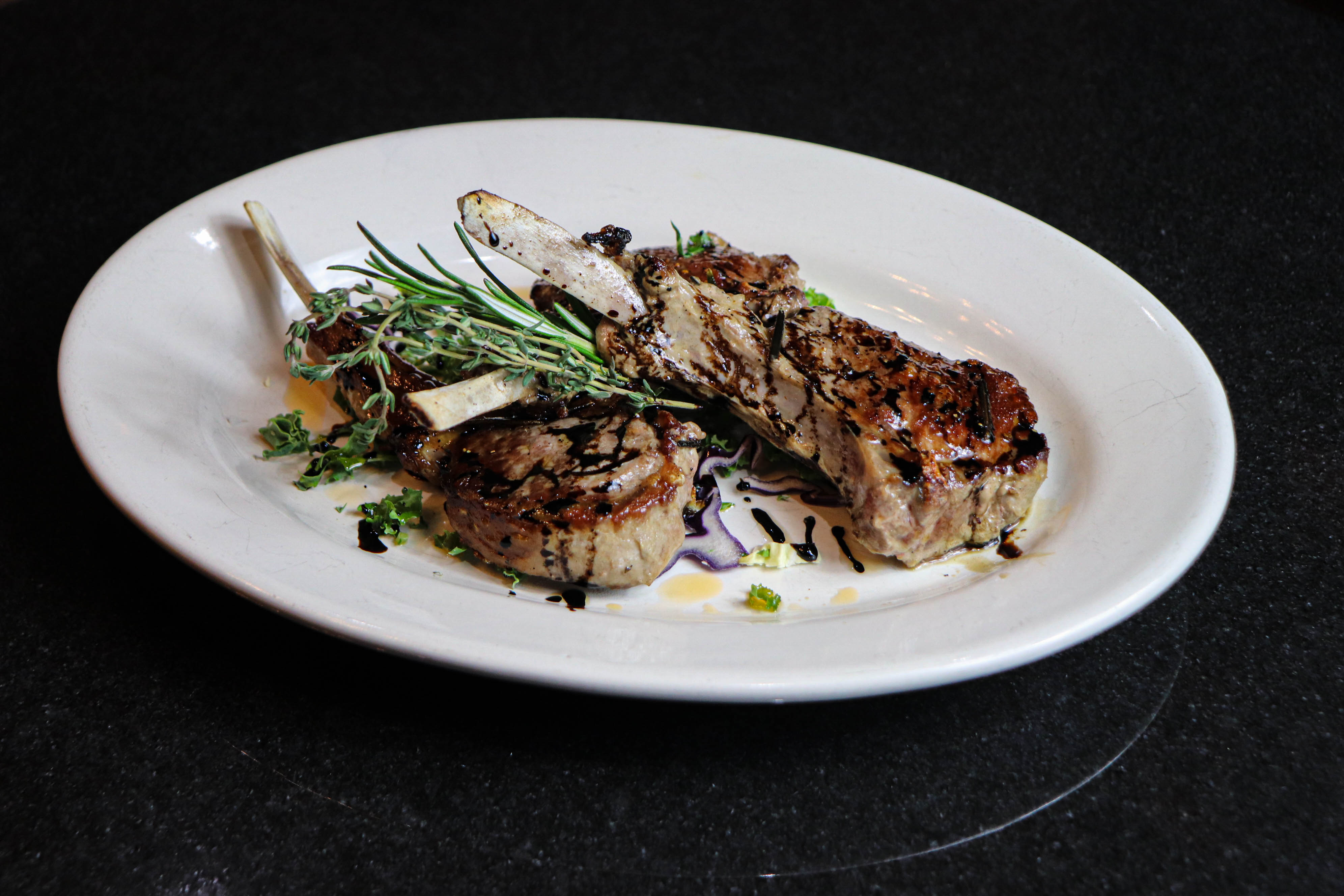 a plate of food on a black surface