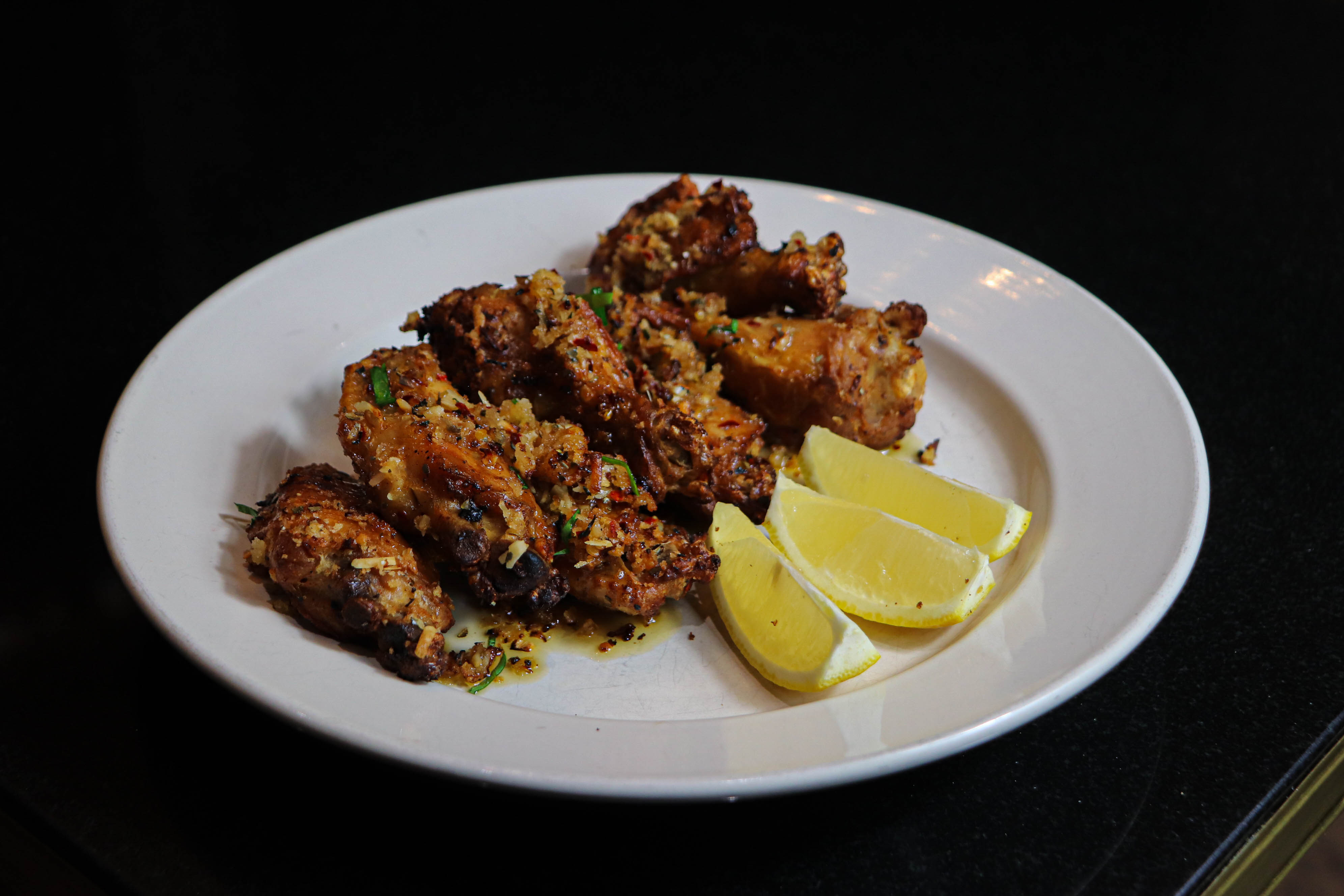 a plate of food with lemon wedges