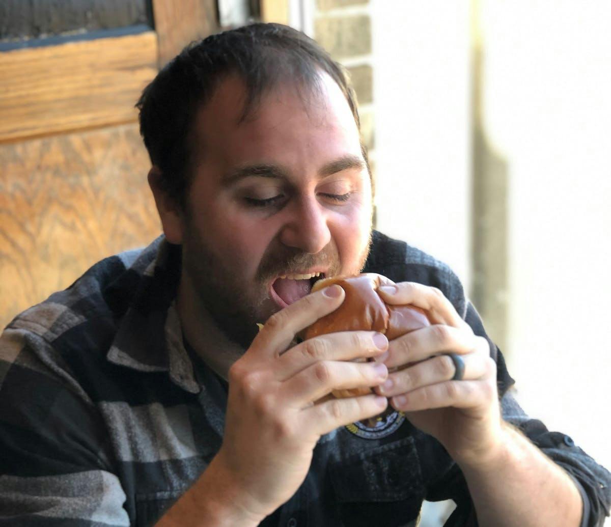a man sitting at a table eating food