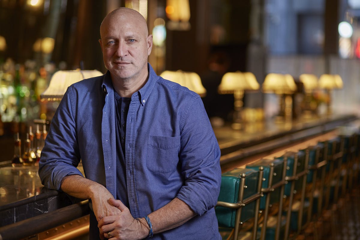 Tom Colicchio sitting at a table