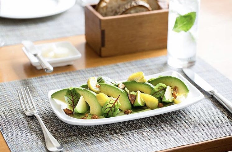 a plate of food sitting on top of a wooden table