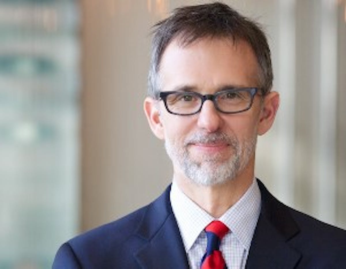 a man wearing glasses and a suit and tie