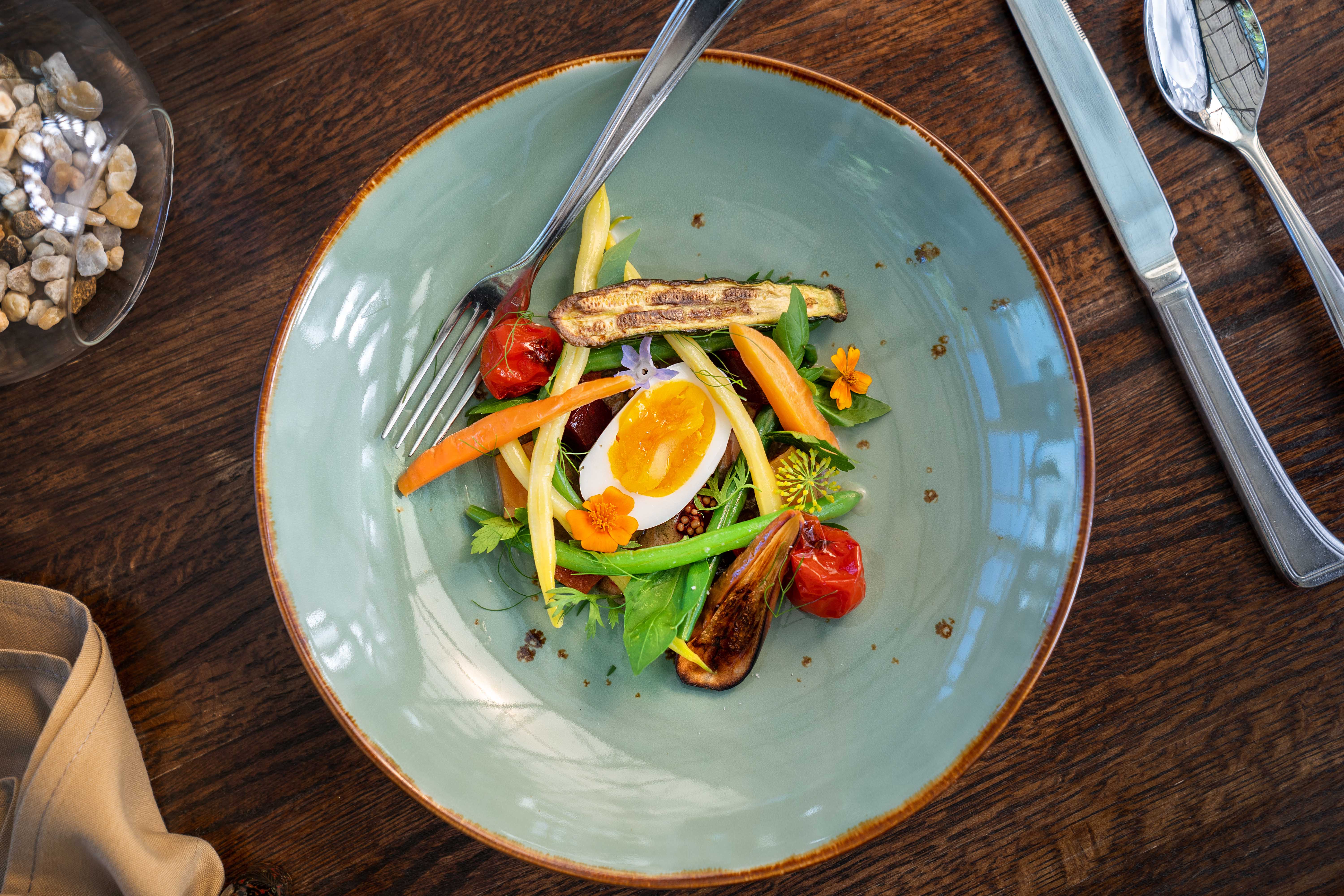 a plate of food sitting on top of a wooden table