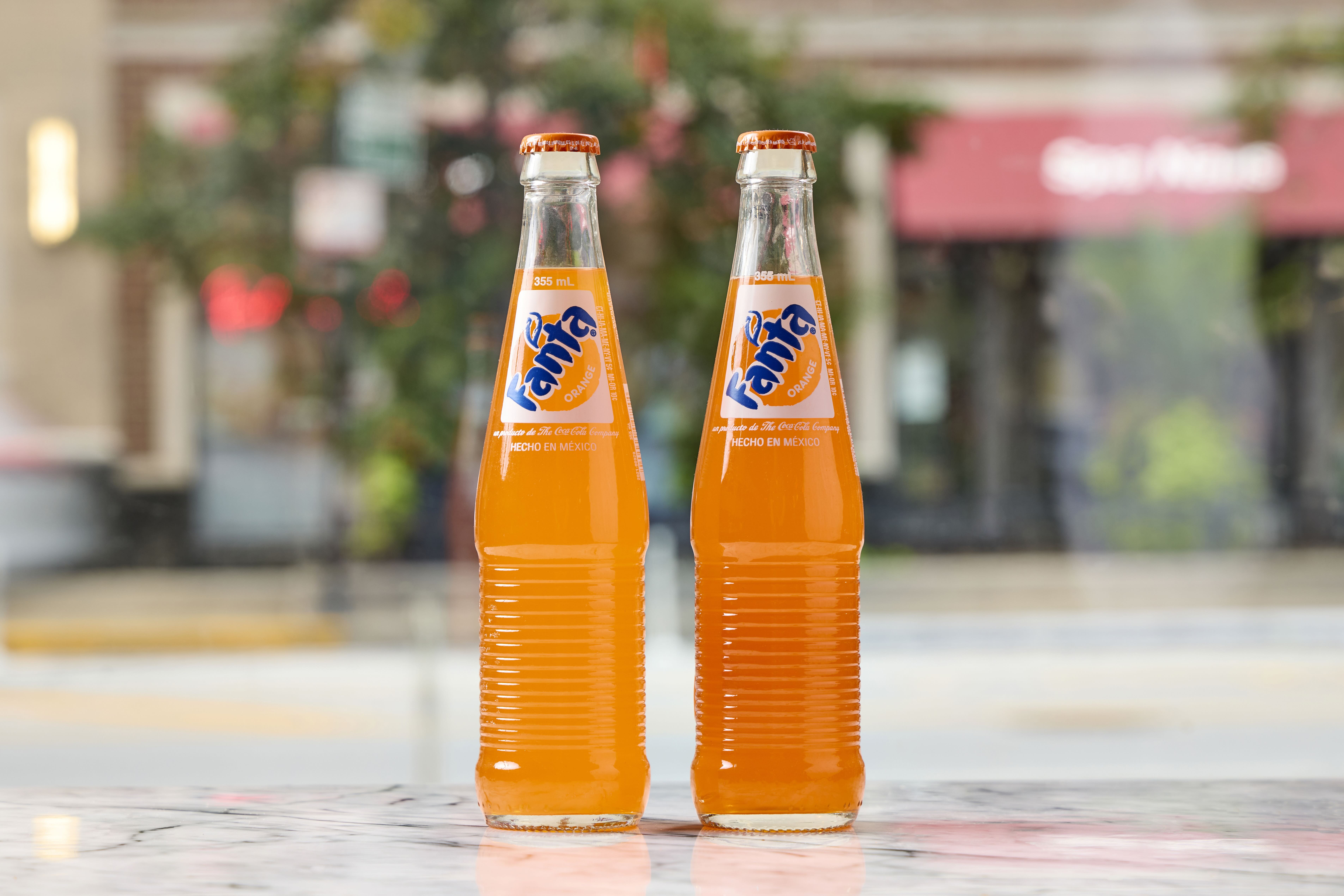 two bottles of orange liquid
