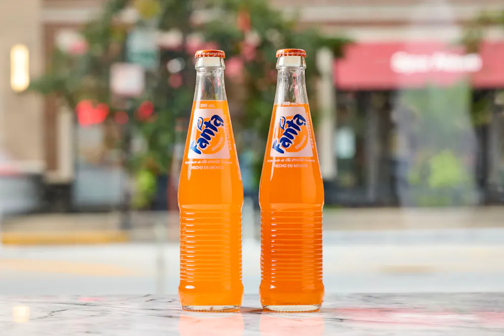 two bottles of orange liquid