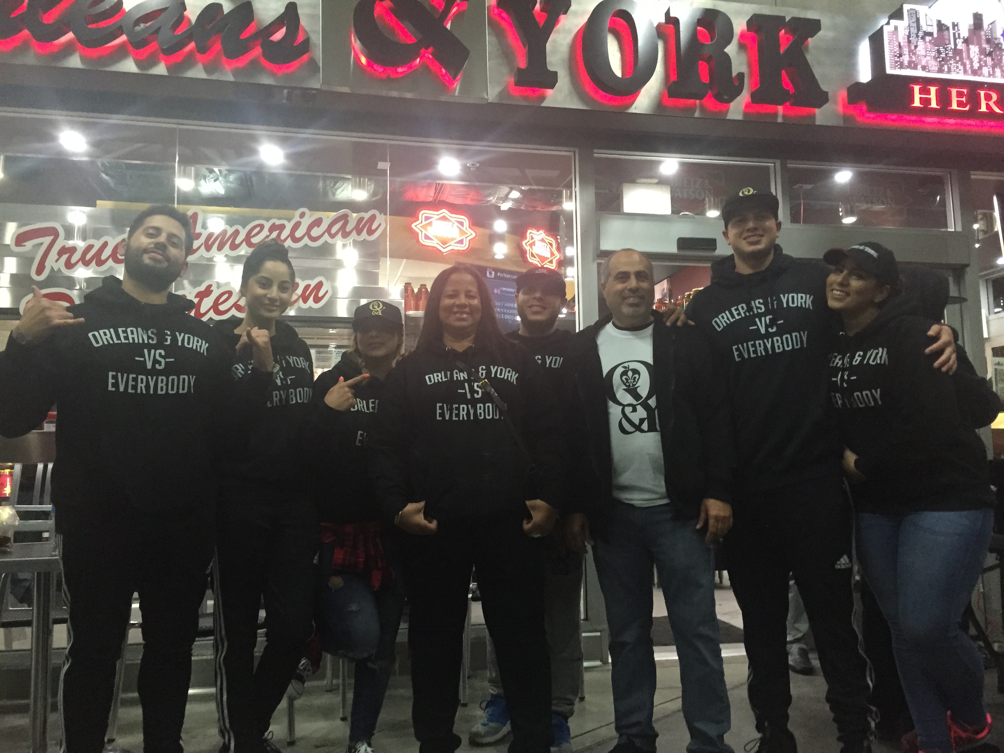 a group of people standing in front of a store