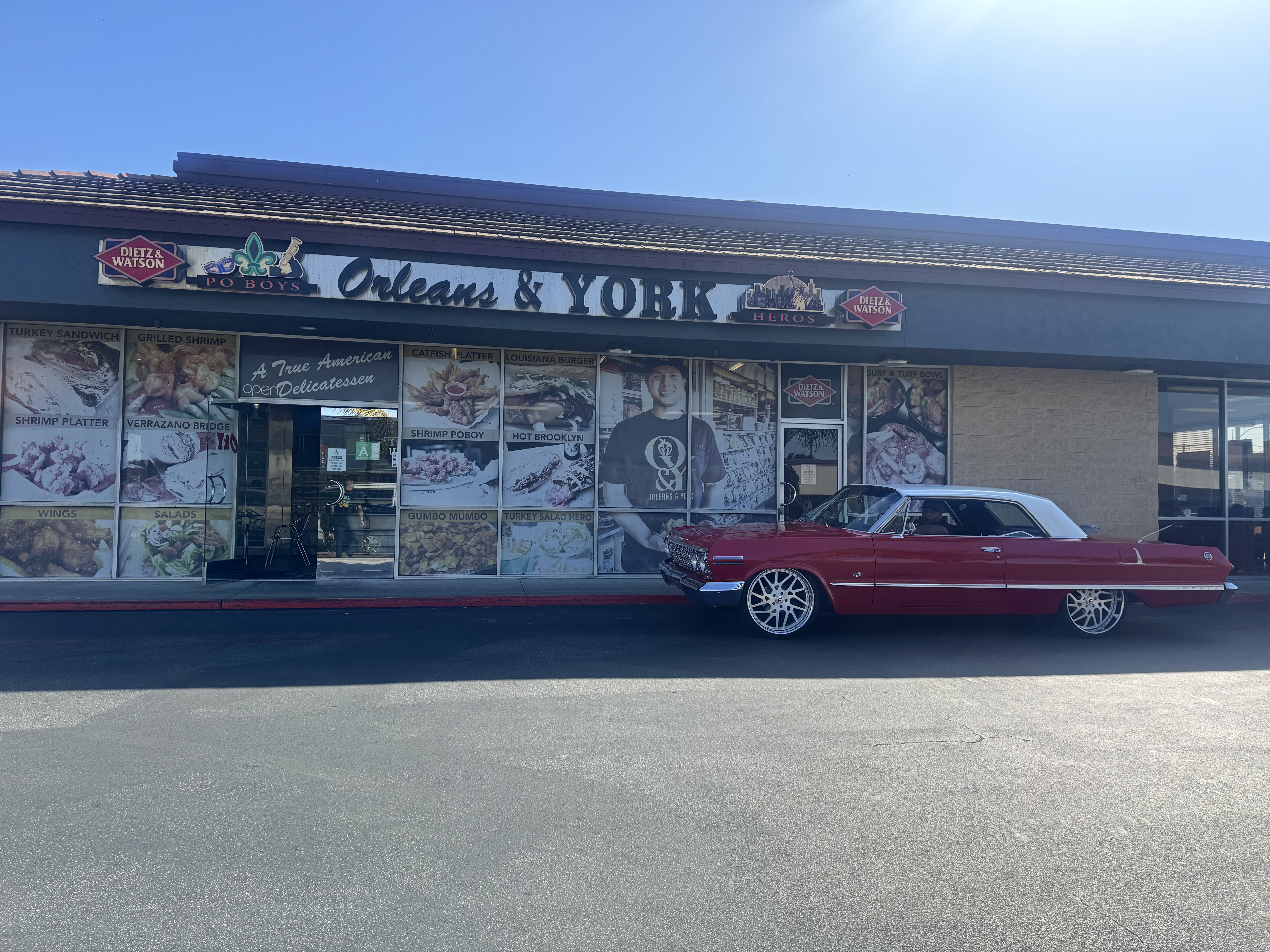 a red car parked in front of a store