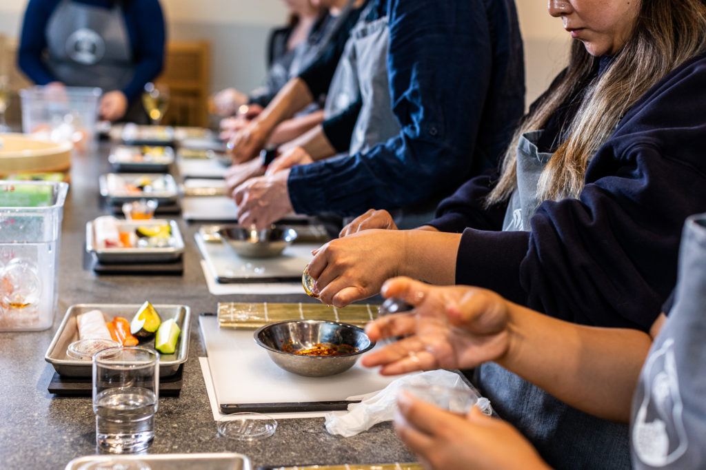 a group of people sitting at a table with food