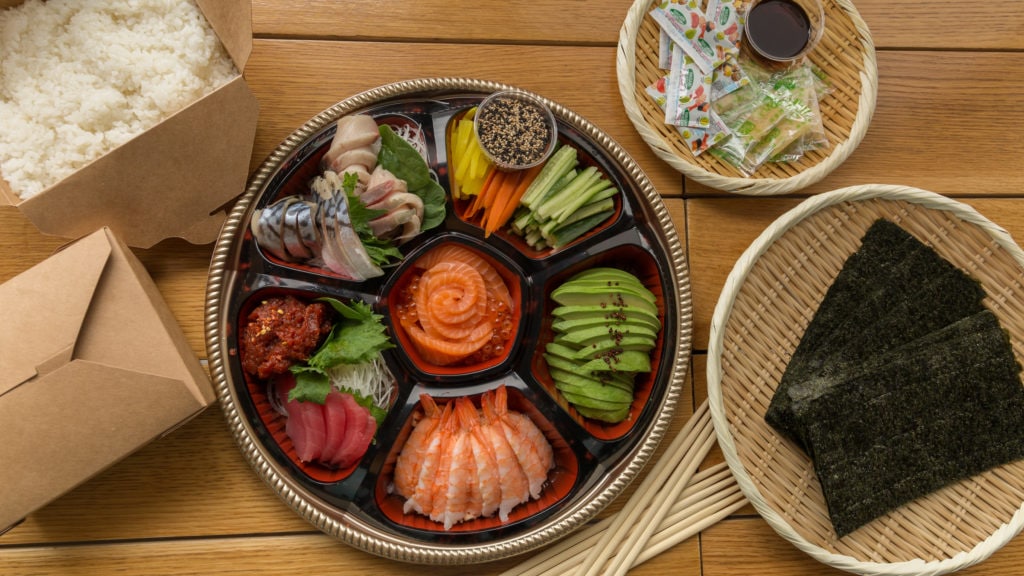 a bowl of food sitting on top of a wooden table